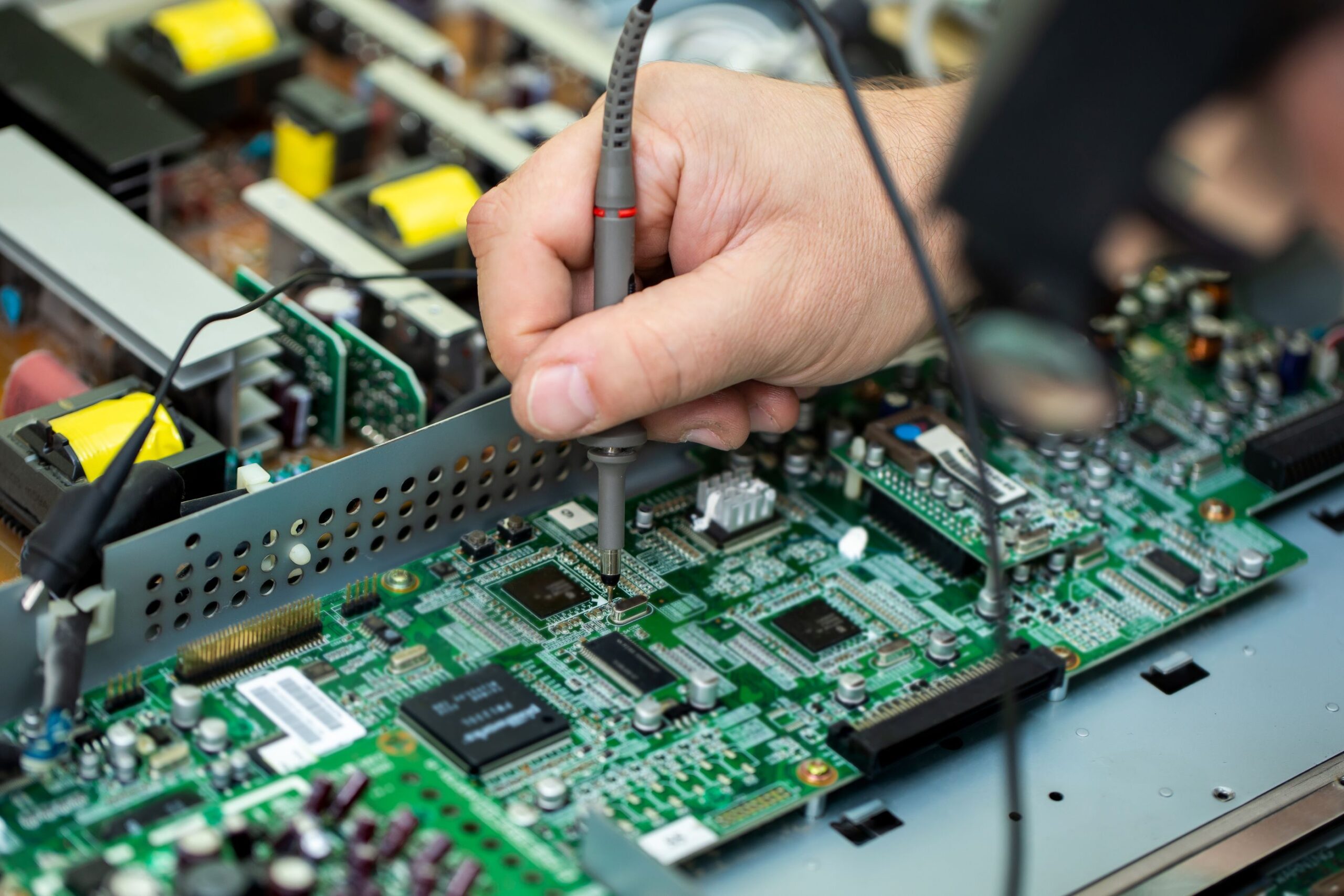 an-electrician-measures-the-voltage-while-repairing-an-lsd-tv-in-a-service-center